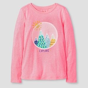A pink shirt that says explore with mountains